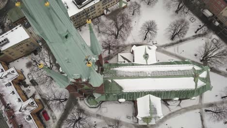 Wide-top-down-view-slowly-changing-to-spiral-downward-movement-around-clock-of-famous-tourist-attraction-in-downtown-Stockholm,Klara-Church