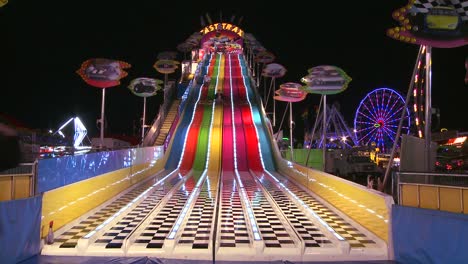 a slide at a carnival at night