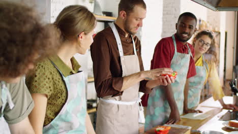 young people cooking with chef during culinary class