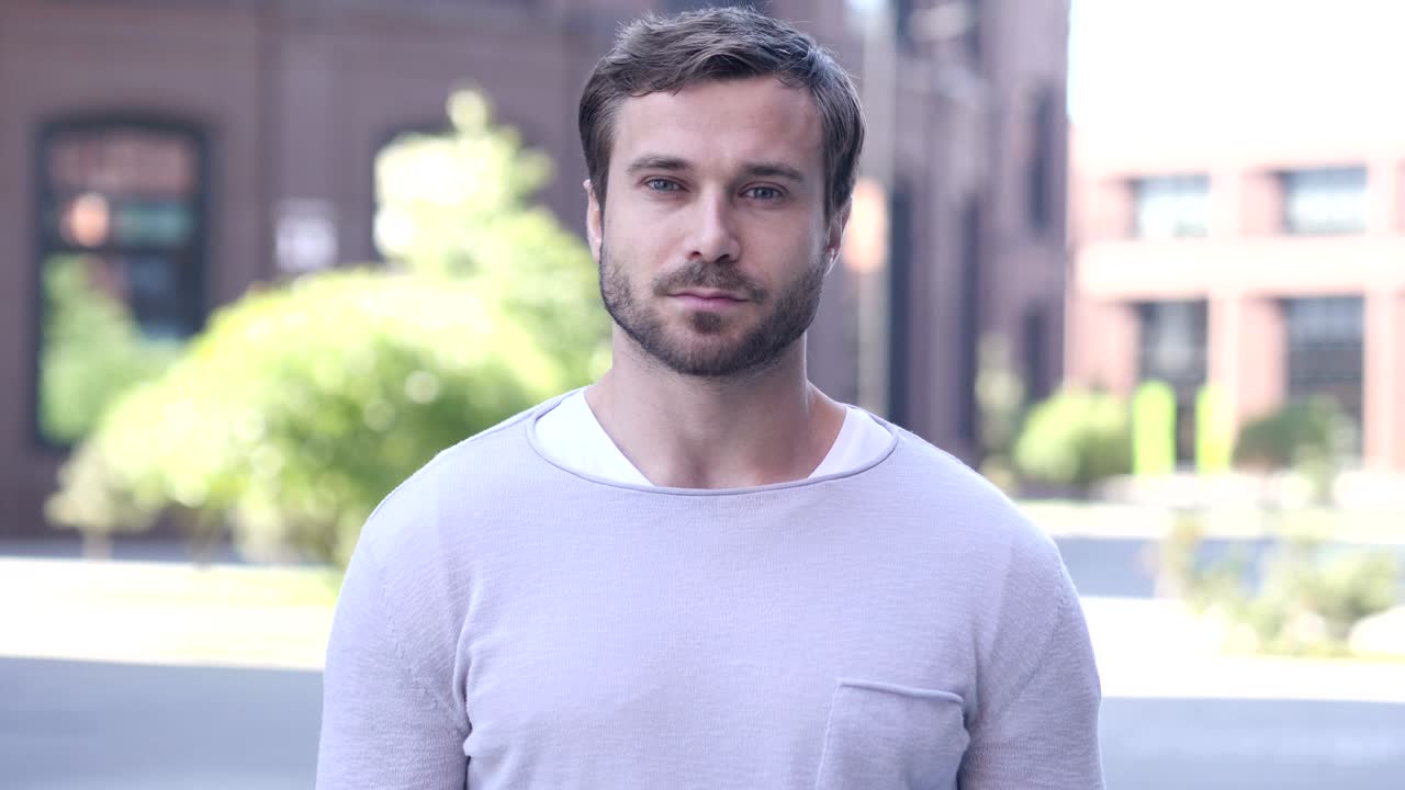 Portrait of Serious Handsome Man Looking at Camera