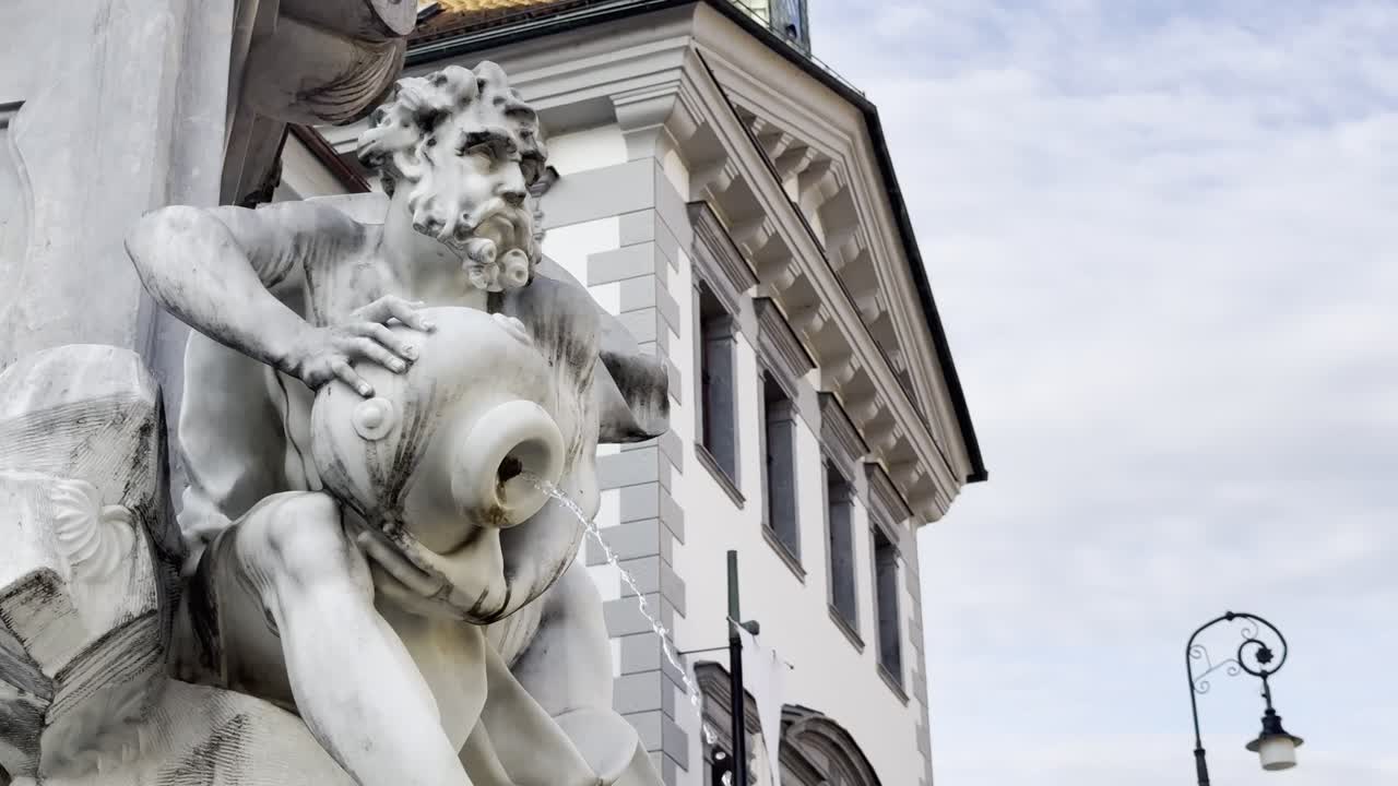 Marble Robba Fountain up close in Mestni Trg with Ljubljana Town Hall in the background