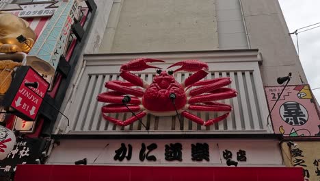 mechanical crab signboard animating above restaurant.