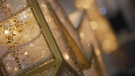 close-up of intricate gold frame with detailed pattern glowing warmly, surrounded by blinking white lights, the blurred background features circular bokeh