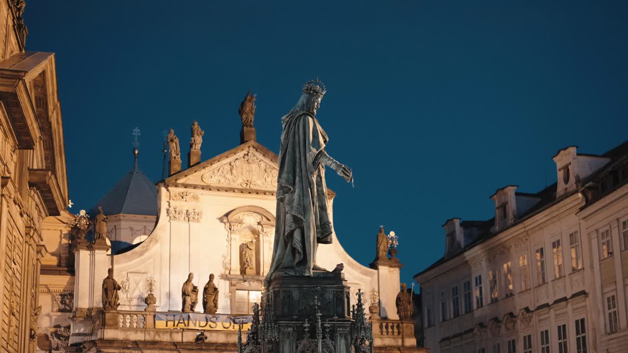 Nighttime view of King Charles IV statue near Prague's bridge gate square
