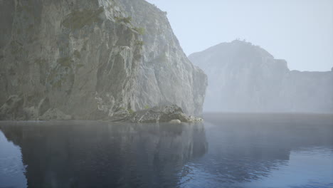 misty lake and cliffs