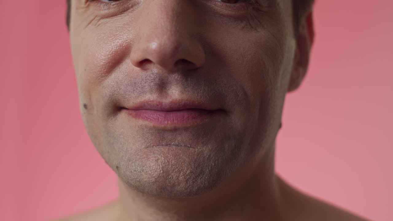 Male Face with Real Skin Texture on Pink Background
