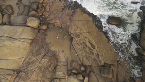 drone shot of rocks and ocean