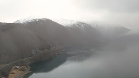 Aerial-view-of-a-snow-capped-mountain-range-and-fjord-in-Tysfjord,-Norway