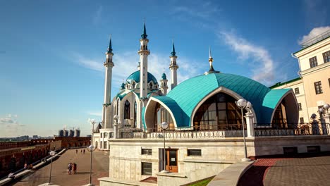 crowd of tourists walk along square near kul sharif mosque