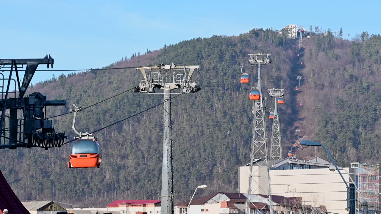 Gondola lift moving above the mountains in Piatra Neamt, Romania