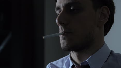 hombre triste fumando