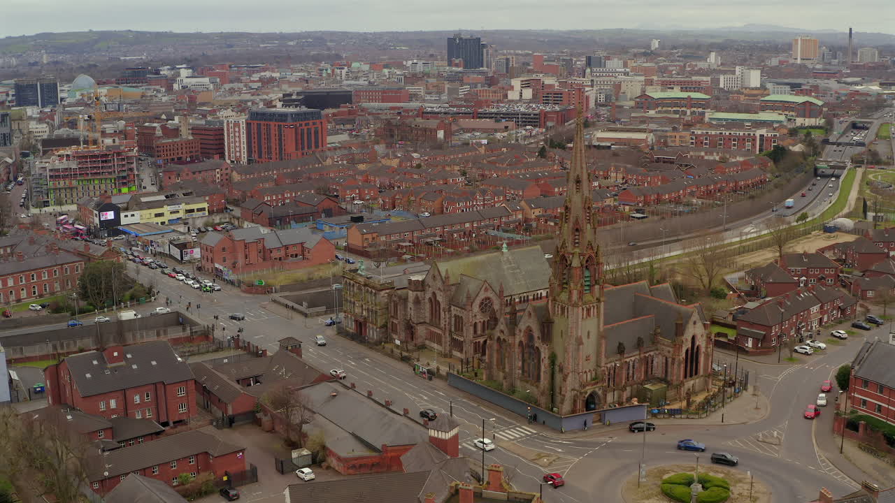 Aerial tracking shot over busy Belfast city centre with Carlisle Memorial Church in foreground.