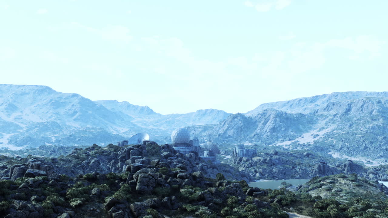 Military base nestled in rugged mountain terrain during daylight hours