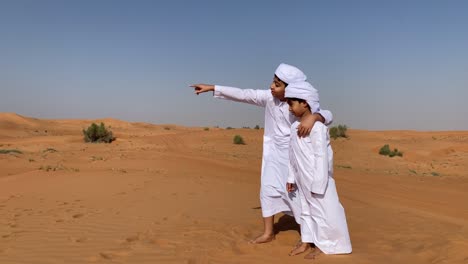 two arabic children in desert