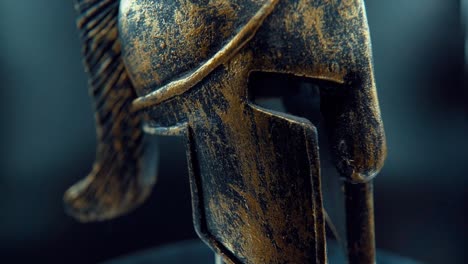 a close up macro cinematic shot of a spartan face design, warrior metal bronze helmet, on a rotating stand, studio lighting, full hd video, slow motion 120 fps