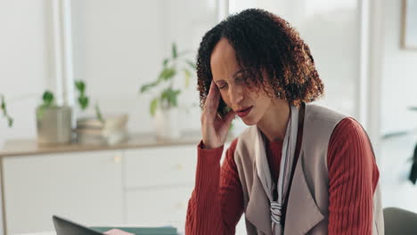 woman experiencing headache and stress at the office