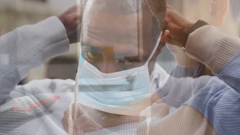 Composite-video-of-african-american-man-wearing-face-mask-against-caucasian-boy-studying-at-school