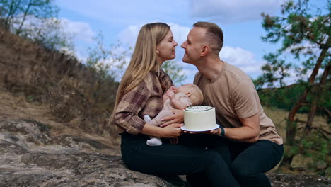 family celebrates baby's birthday in nature