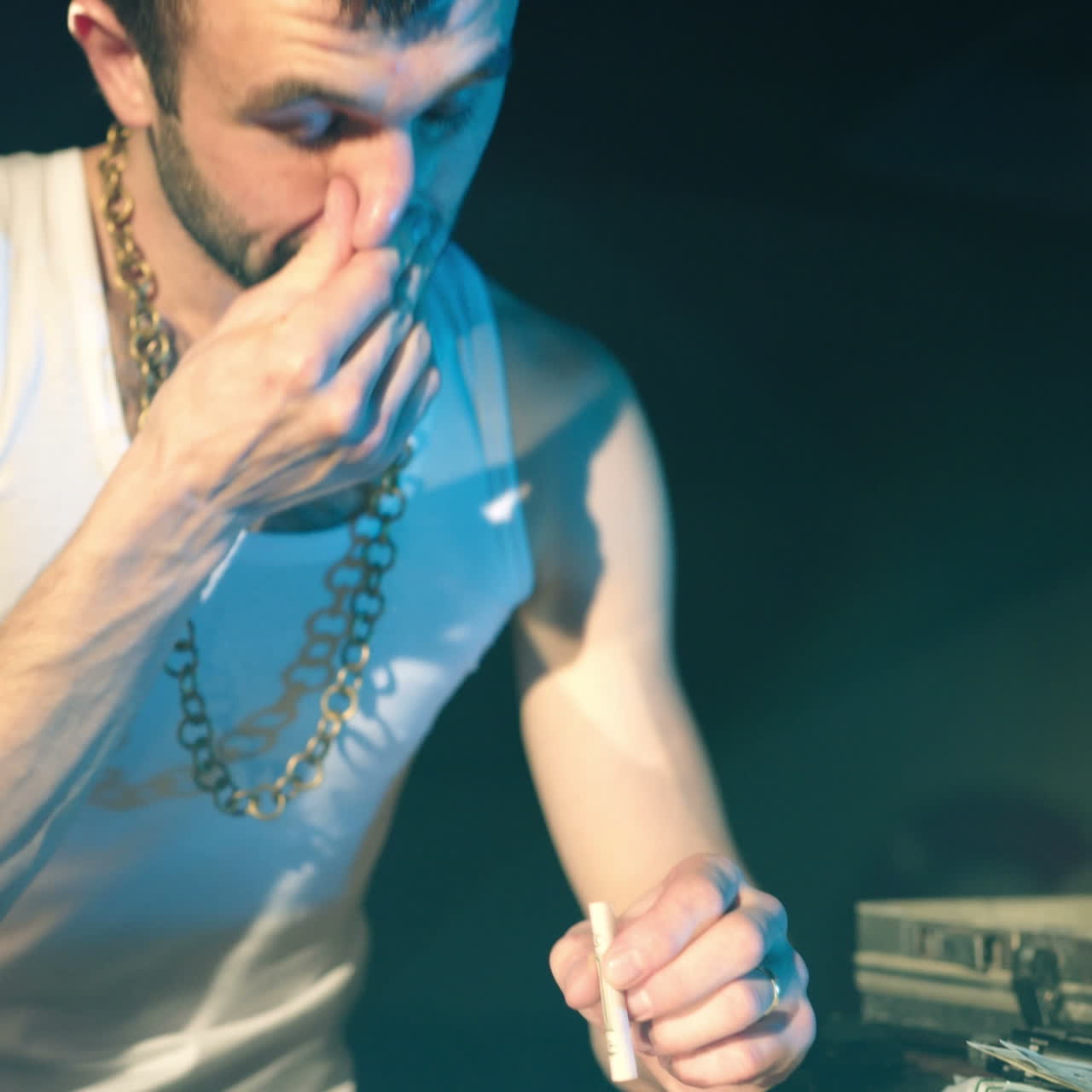 Young man sniffs cocaine on a mirror with a roll of banknotes. Abuse of drugs. Criminal Business