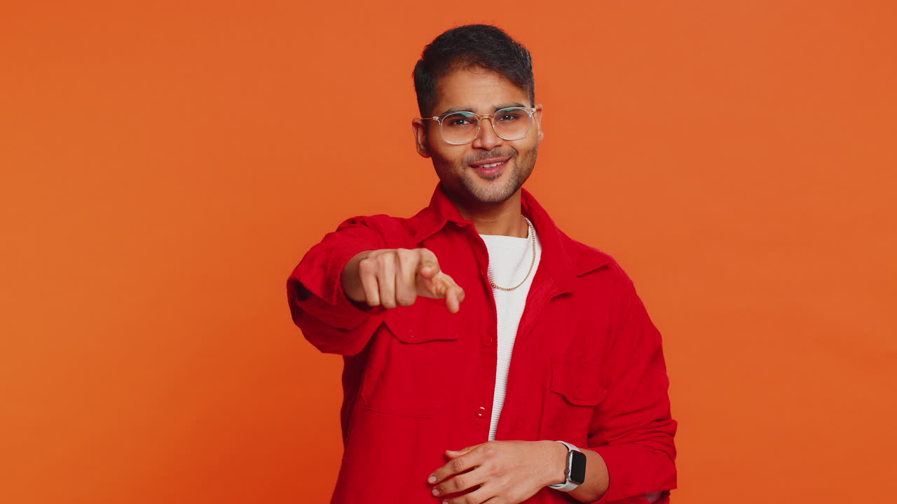 Happy indian smiling man pointing finger to camera making winner choice showing direction select