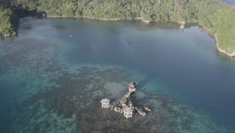 luxury resort cottage and cabins by the crystal clear water surrounded by the lush coastal mountains in the tropical island of the philippines in summer