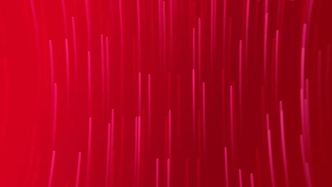 animation of glowing light trails moving over red background