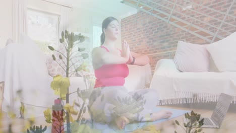 animation of flowers over caucasian woman practicing yoga at home