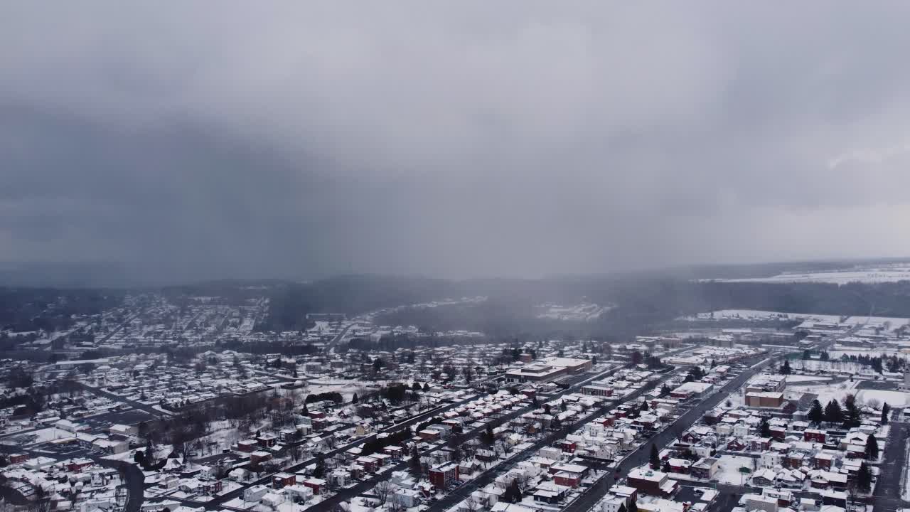 Foggy cold snow weather, snow covered neighborhood on winter day, misty cloudy sky in small village, dolly shot backwards, copy space