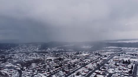 foggy cold snow weather, snow covered neighborhood on winter day, misty cloudy sky in small village, dolly shot backwards, copy space