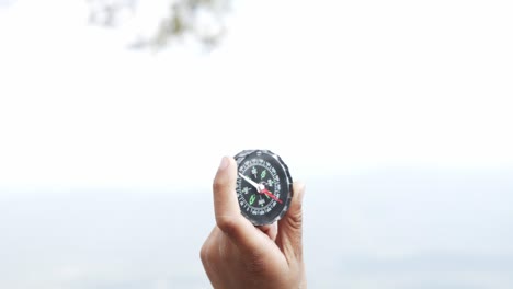 hand holding a compass for travel.