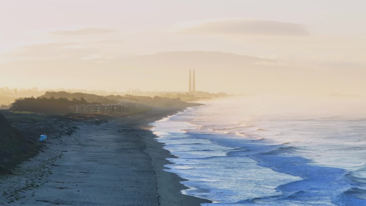 Moss Landing Powerplant Twin Towers sunrise early morning mist fog Pajaro Dunes California aerial drone Santa Cruz surfer waves sand Monterey Bay Pacific Ocean Manresa Sunset State Beach static shot