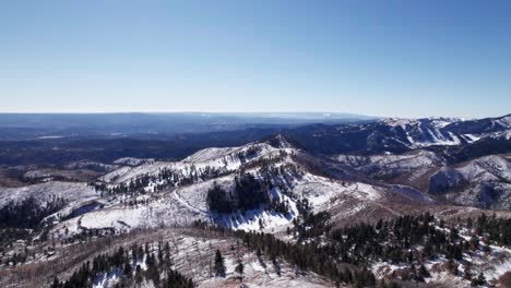 high altitude drone aerial view of mountains and snowy valleys in nm, us
