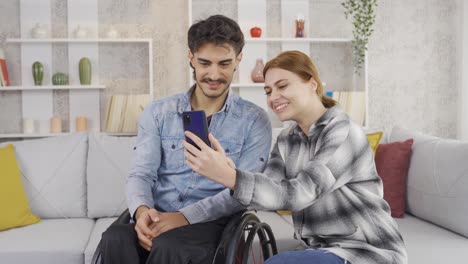 happy disabled man and his girlfriend spending time at home.