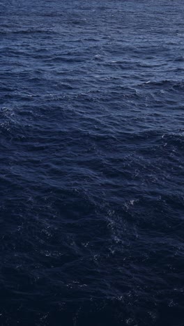 Ocean-Water-Close-Up-Background-with-Sea-and-Horizon,-Gentle-Waves-and-Swell-in-Vast-Expanse-of-Endless-Water-from-Ship-or-Boat,-Vertical-Video-for-Social-Media,-Instagram-Reels-and-Tiktok