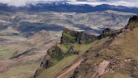aerial view of steep mountains and valley of iceland in summer. snowy peaks of hills in distance. aerial approaching shot. wide shot. vik, hatta.