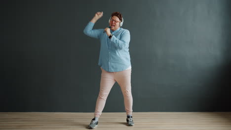 man singing and dancing with microphone