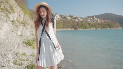 woman in a white dress by the lake