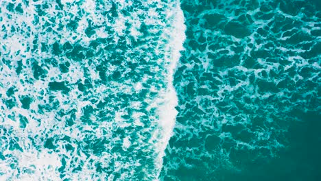 Waves-crashing-over-the-beach-during-sunset