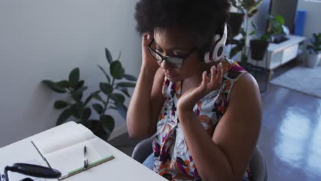 african american female plus size vlogger wearing headphones recording a video blog