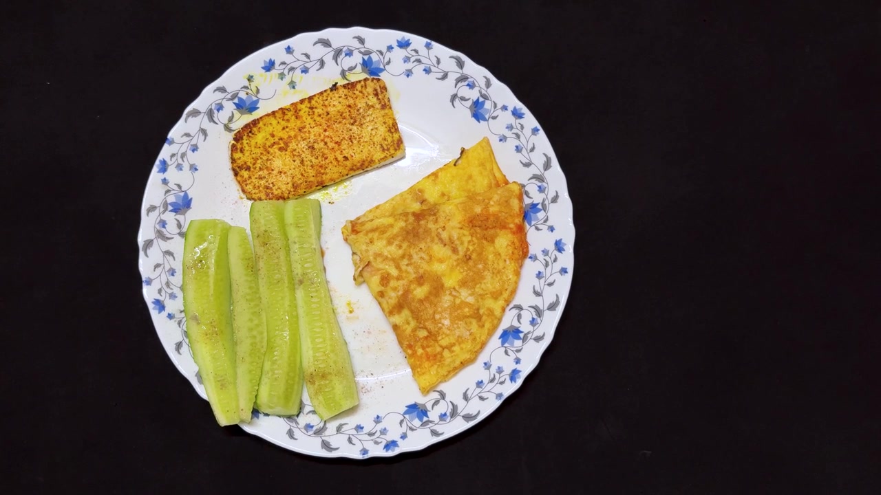 homemade protein packed breakfast featuring golden omelette grilled paneer and cucumber