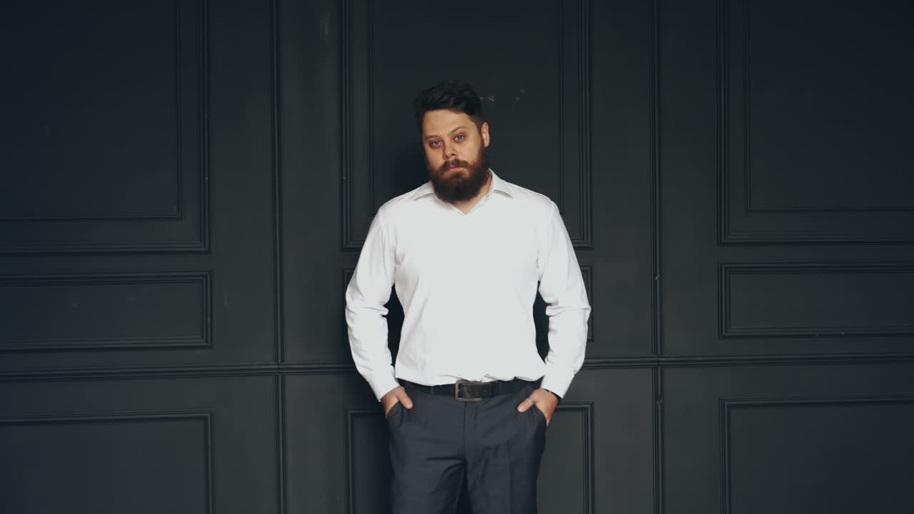 Brutal man in studio. Young casual bearded man posing in studio