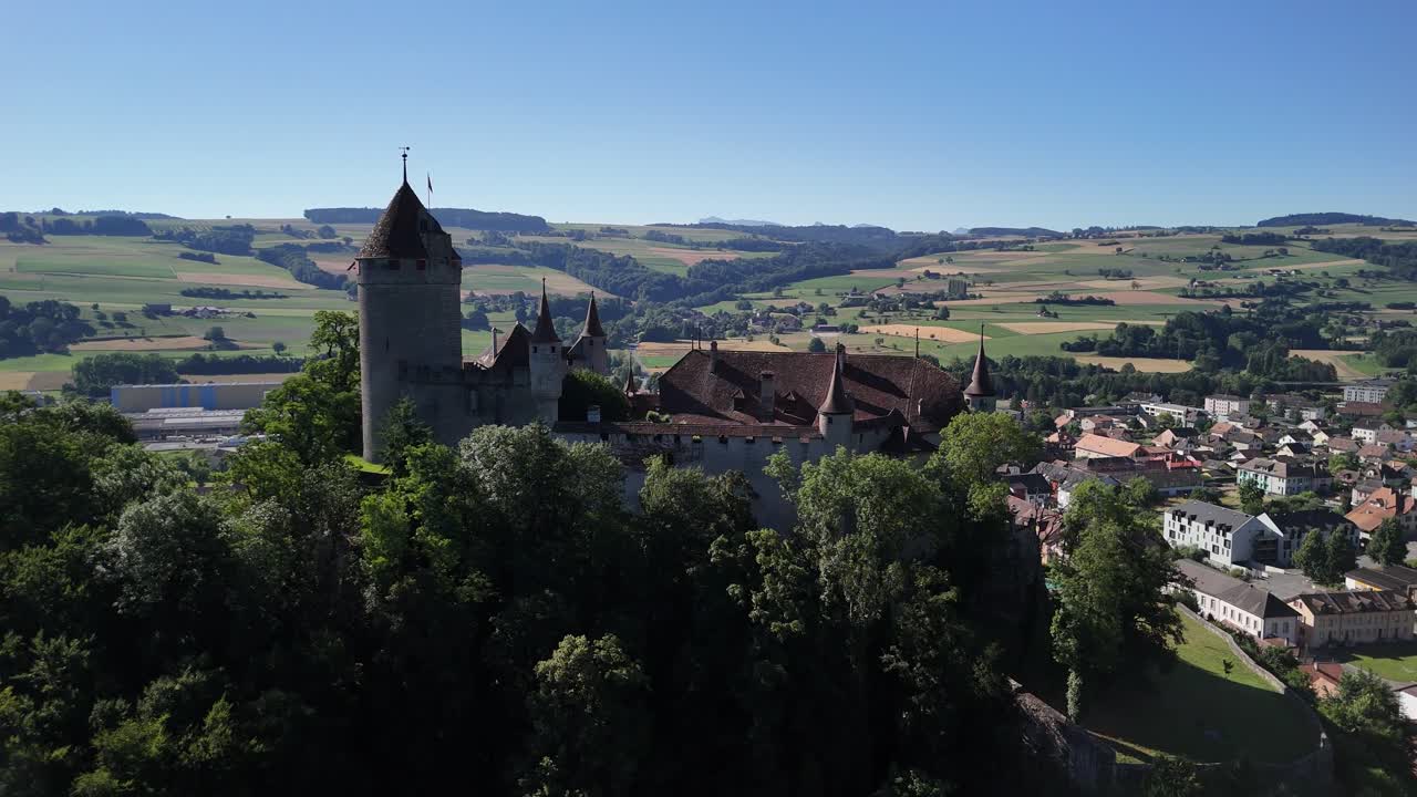 Lucens medieval castle landmark Switzerland aerial drone establish shot town
