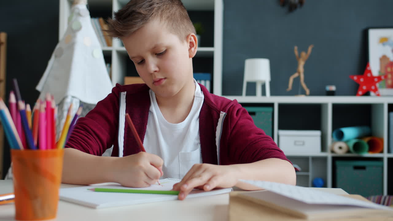 Boy Drawing at a Desk