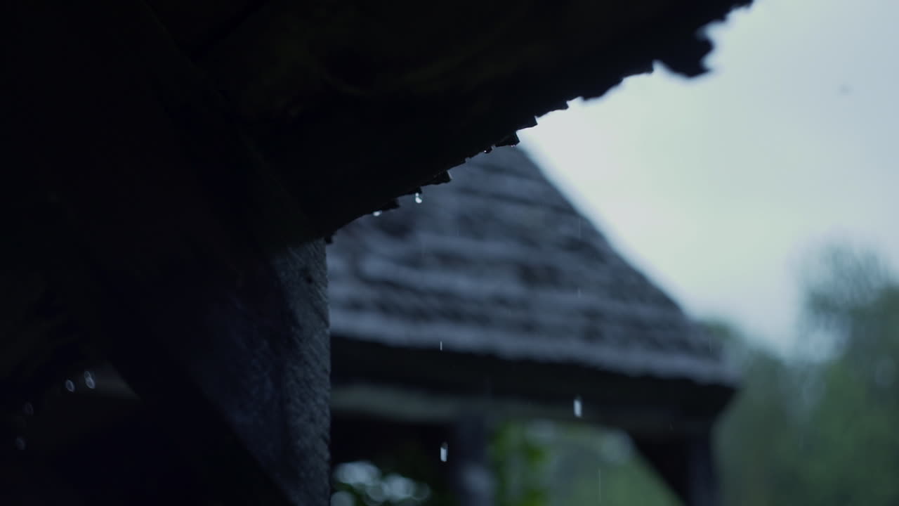 Rain dripping from old wooden roof