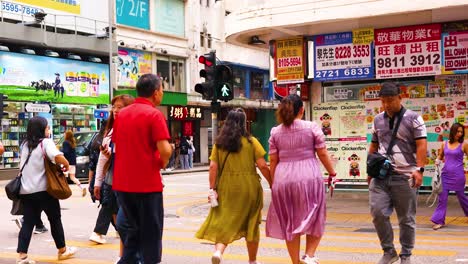 pedestrians crossing a bustling city intersection