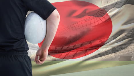 jugador de rugby sosteniendo la pelota contra la bandera japonesa