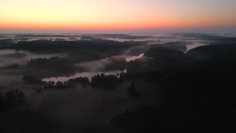 sunrise over misty forest lake