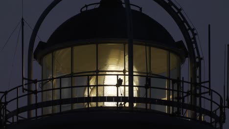 view of bevelled fresnel lens spinning at lighthouse in the evening