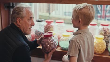 grandfather and grandson enjoying sweets in a candy store