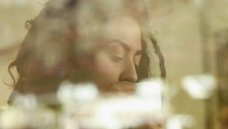 Woman-with-dreadlocks-looking-outside